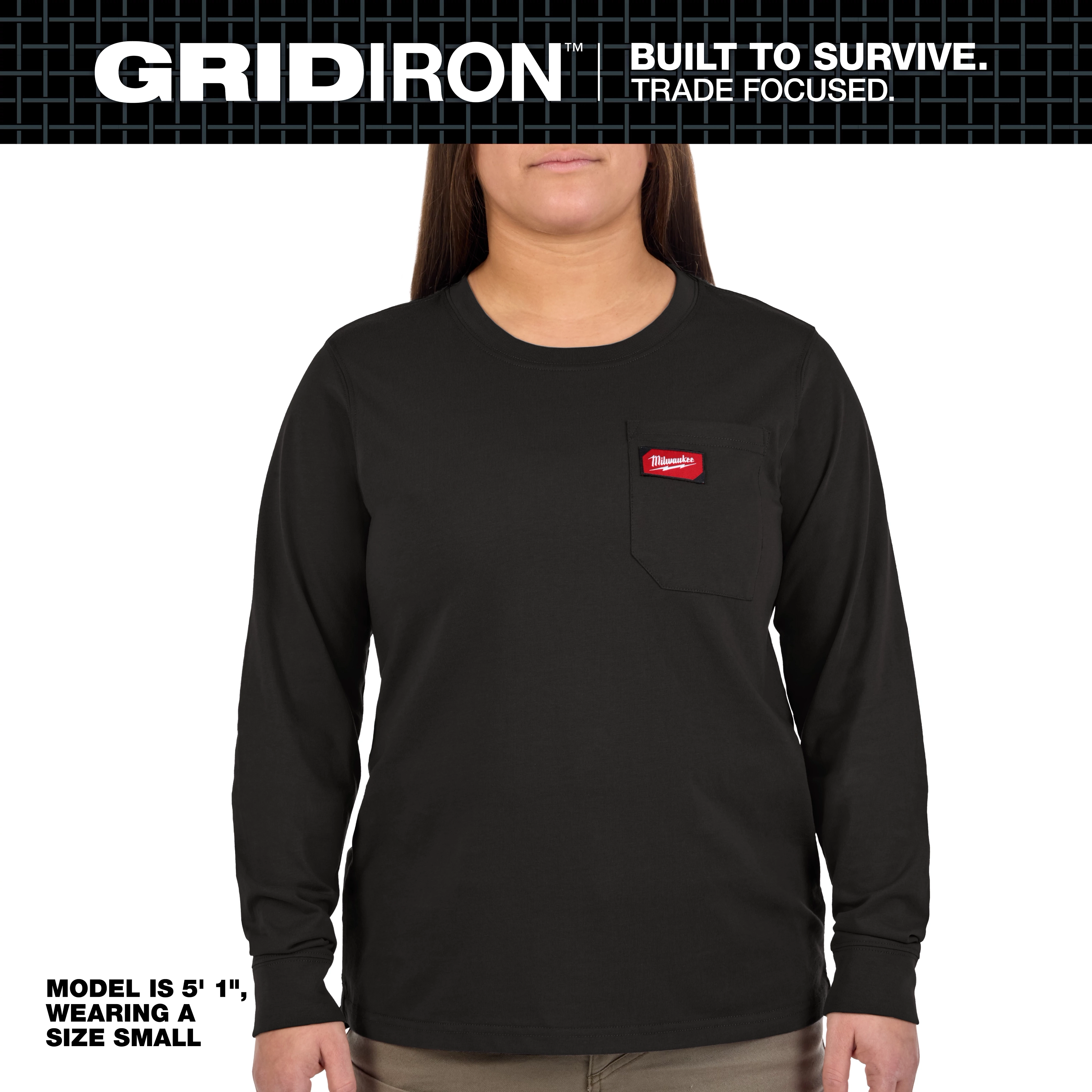 The Women's GRIDIRON™ Pocket T-Shirt - Long Sleeve Black is shown, modeled by a person wearing a size small. The shirt features a front pocket with a red logo patch and is designed for durability. The model is 5'1" tall.