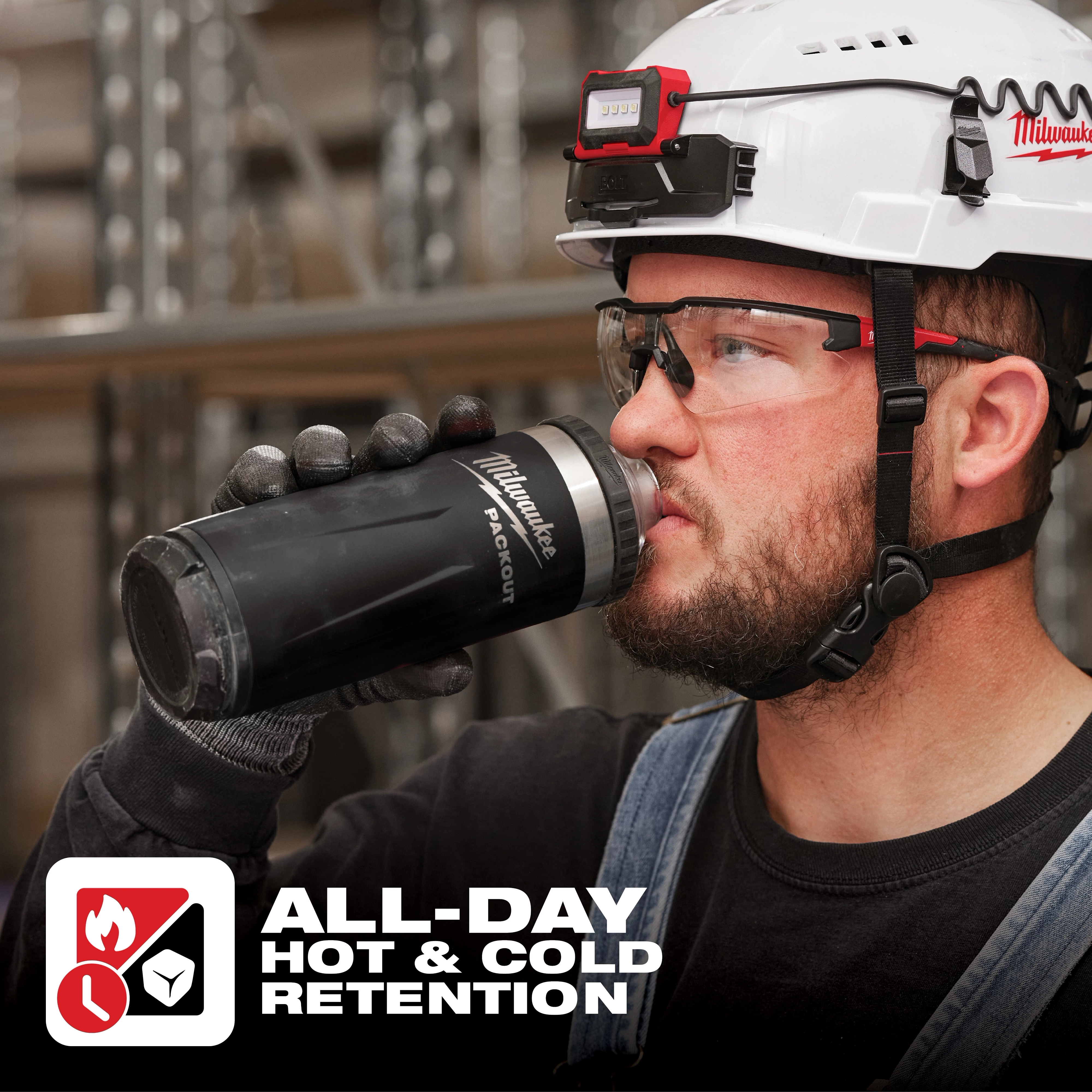 Worker holds an App%20Shot%20Overlay insulated tumbler branded with "PACKOUT" logo, alongside text "ALL-DAY HOT & COLD RETENTION".