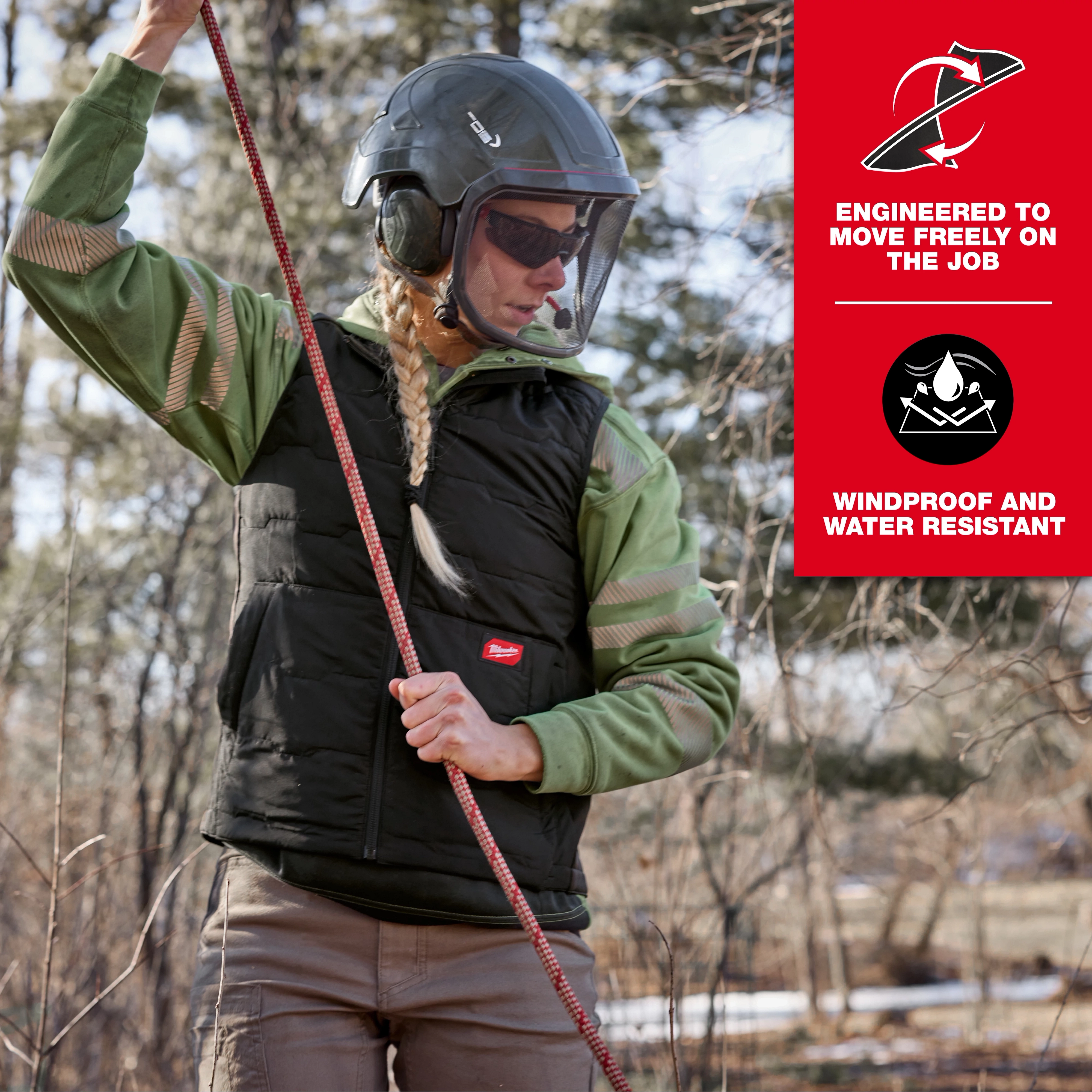 A person dressed in a green shirt and helmet wears the Women's FREEFLEX™ Lightweight Insulated Vest Black, holding a climbing rope outdoors. The vest is advertised as windproof, water-resistant, and engineered for job flexibility.