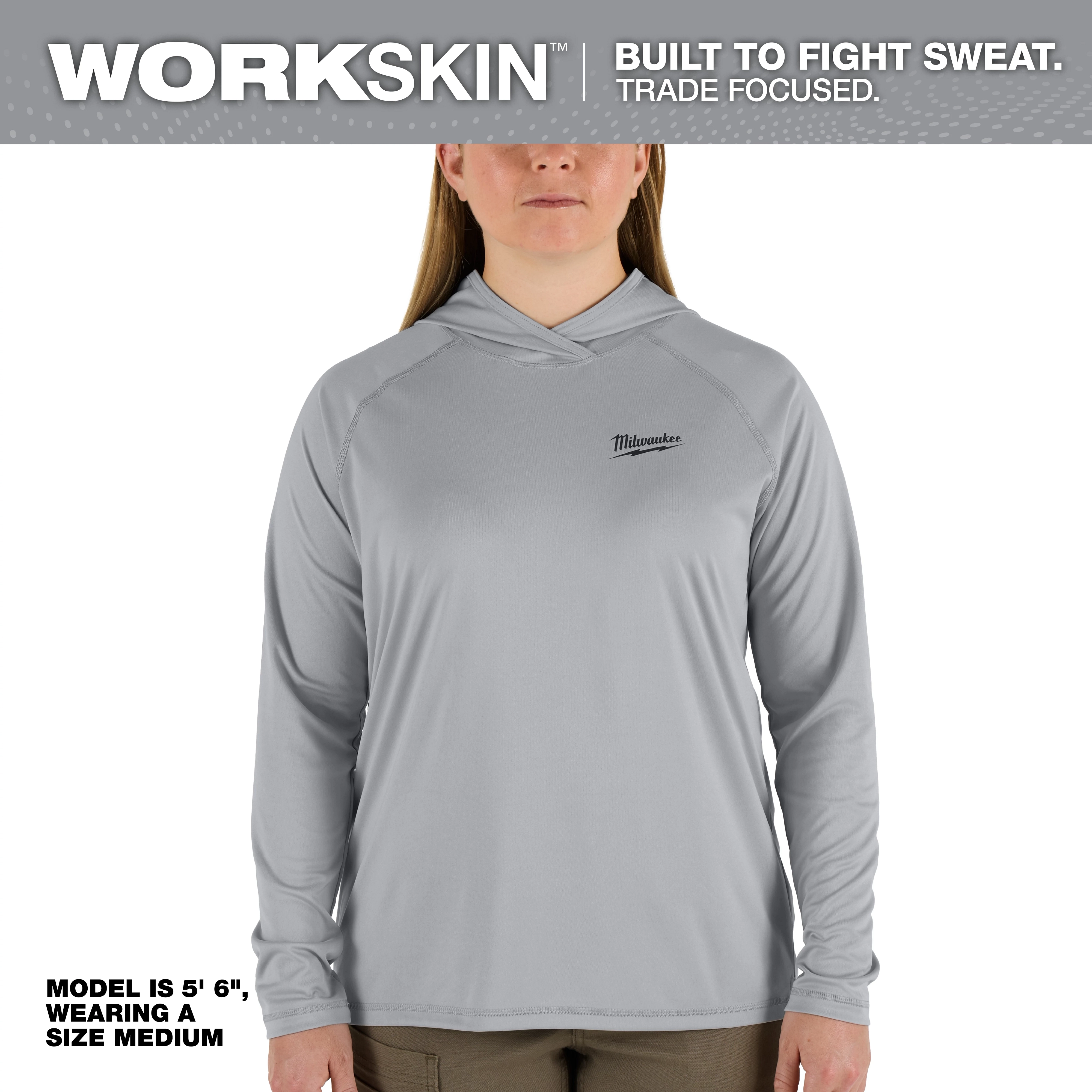 The Women's WORKSKIN Hooded Shirt in gray is showcased on a model standing at 5'6" and wearing a size medium.