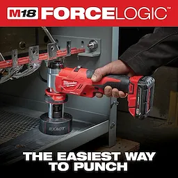 A person uses the Milwaukee M18 Force Logic cordless tool to punch holes in metal electrical panel components. The tool is red and black, featuring a battery pack, and is labeled with the Milwaukee brand name. Text on the image: "THE EASIEST WAY TO PUNCH."