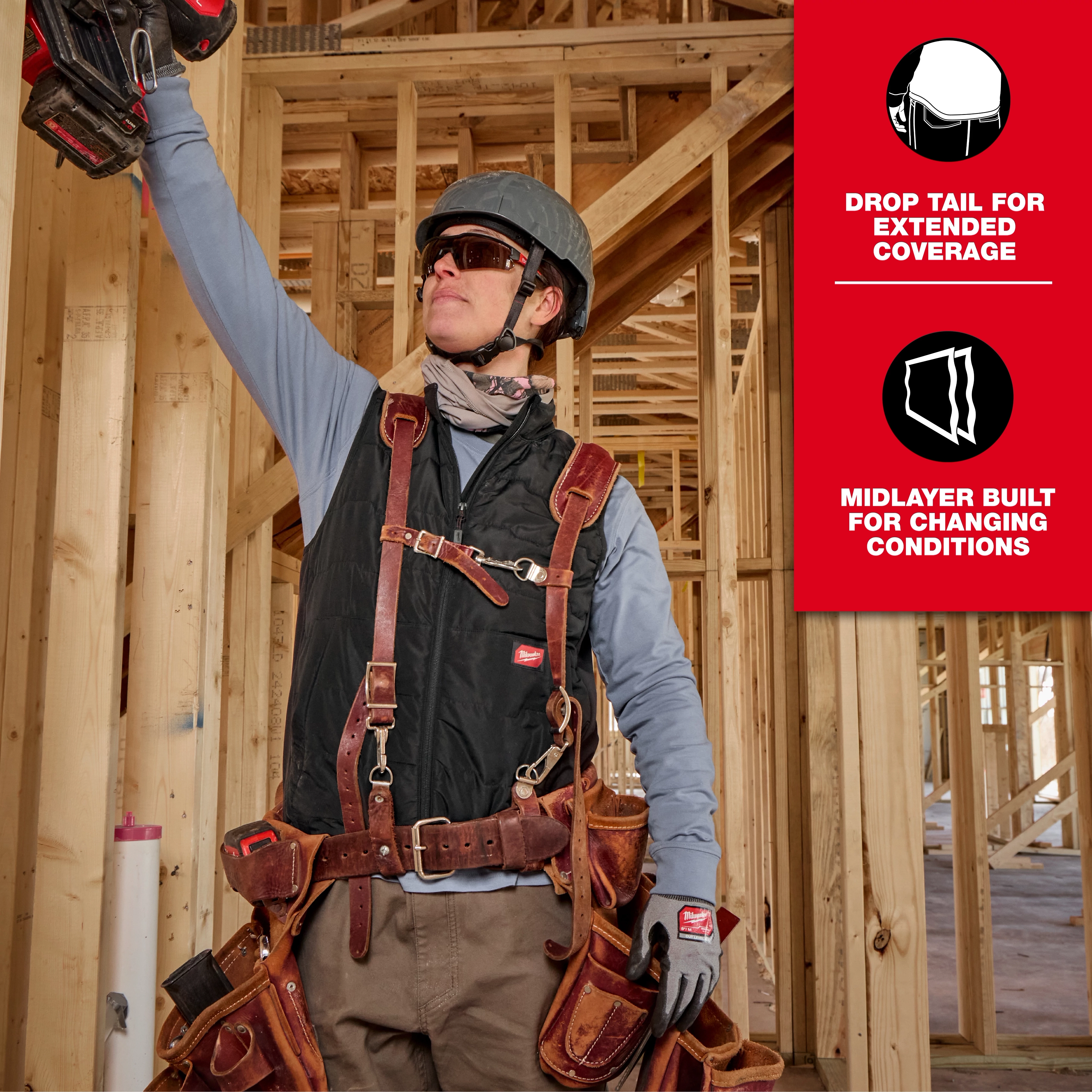 Milwaukee Tool Safety Vest, featuring multiple pockets, drop tail for extended coverage, and a midlayer designed for changing conditions. The worker is wearing the vest in a construction site.