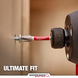 A SHOCKWAVE™ Philips Bit, branded by Milwaukee, is attached to a power drill driving a screw into a wooden surface. The text "ULTIMATE FIT" and the SHOCKWAVE™ logo with "IMPACT DUTY" appear at the bottom of the image.