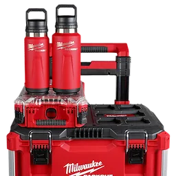 Two red PACKOUT 24oz Insulated Bottles with Chug Lids are placed on a stack of red tool storage boxes branded with "Milwaukee."
