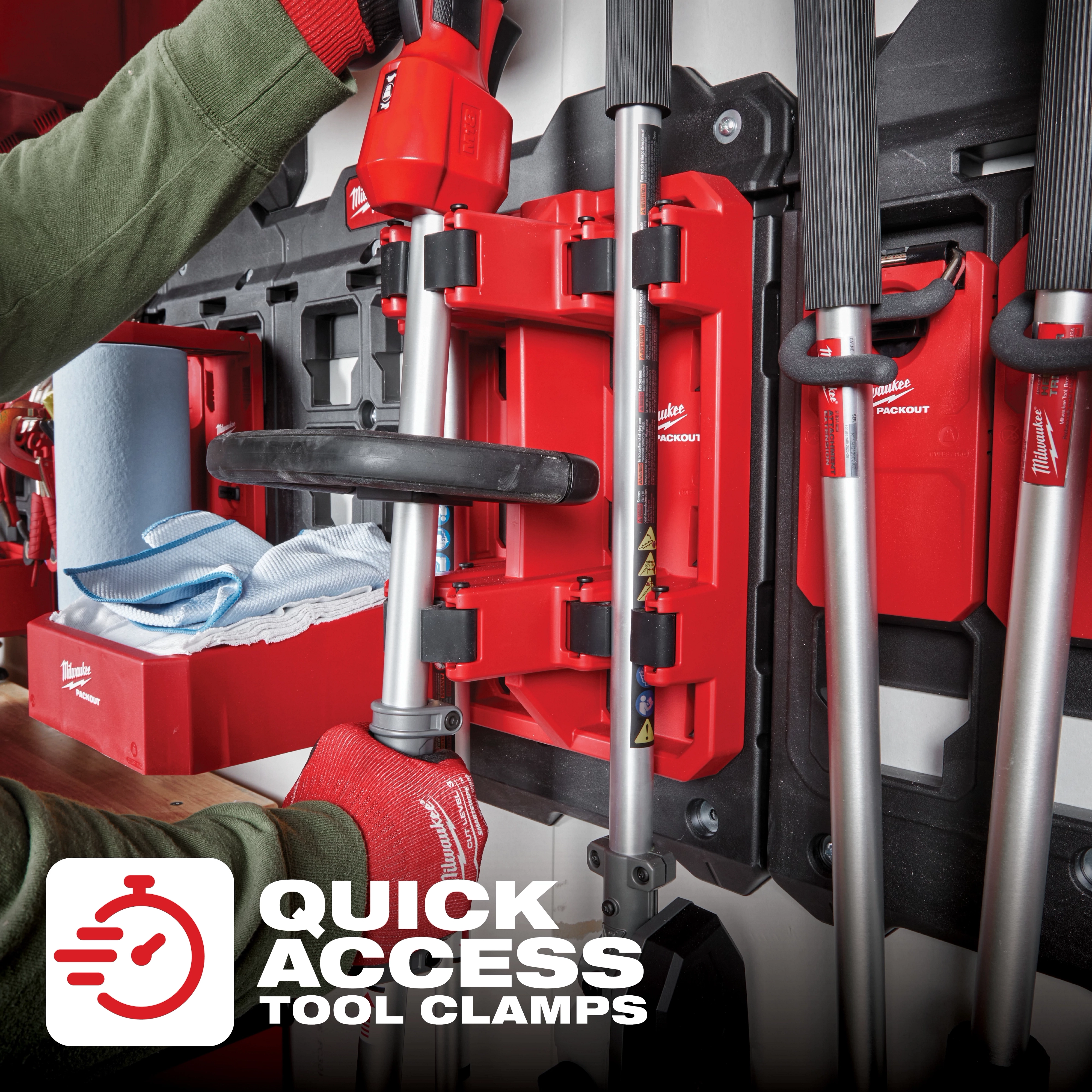 Milwaukee PACKOUT Long Handle Tool Rack mounted on a wall with tools and quick access clamps. Text reads "Quick Access Tool Clamps."