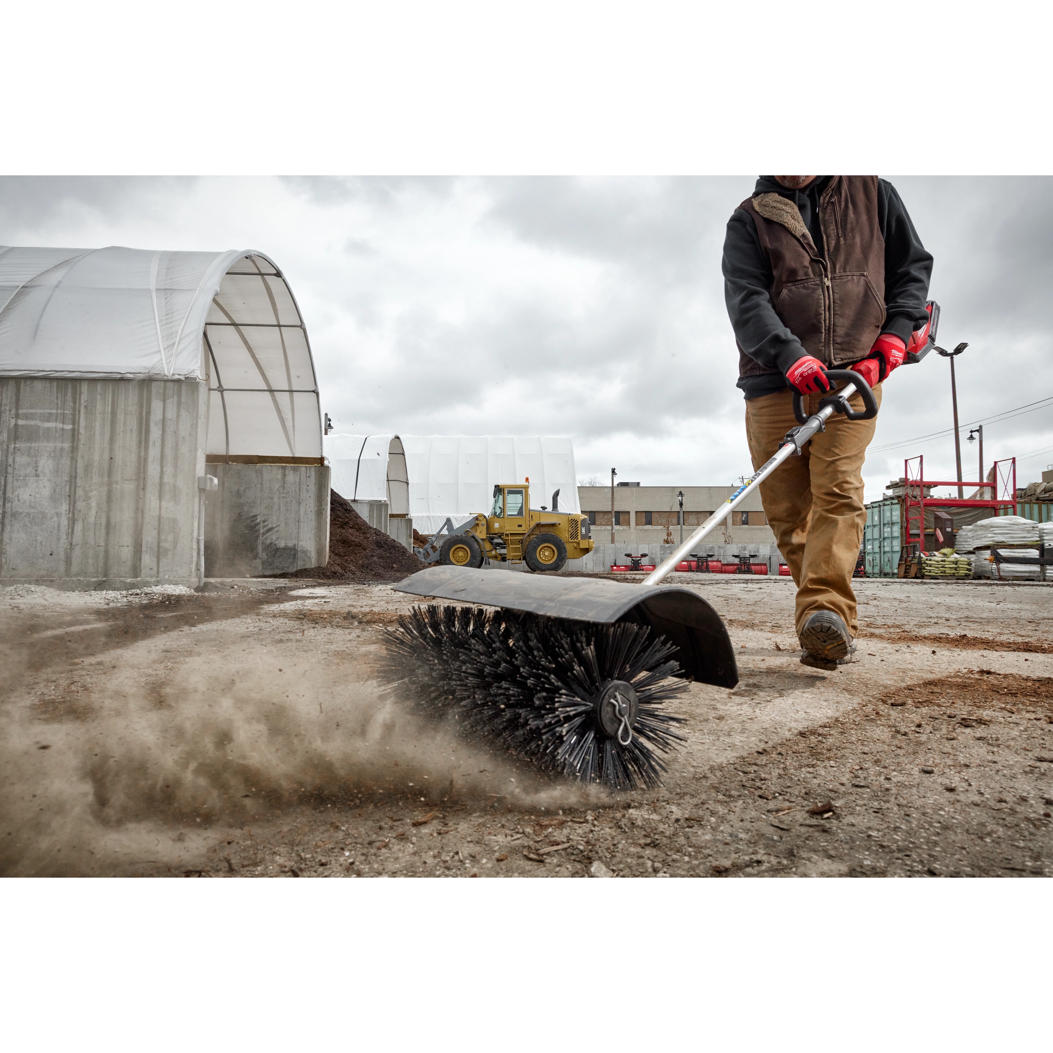 Worker using the M18 FUEL QUIK-LOK Bristle Brush Attachment