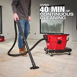 The M18 FUEL™ NEXUS™ 6 Gallon Wet/Dry Vacuum w/ PACKOUT™ Compatibility & VACLINK™ is shown in a workshop setting. The vacuum is bright red, mobile with wheels, and connected to a black hose. It advertises "Over 40 min of continuous cleaning."