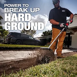 A person uses a power tool to break up hard ground in a yard. The background shows a house, a black SUV, and a partly cloudy sky. The text on the image reads, "POWER TO BREAK UP HARD GROUND."