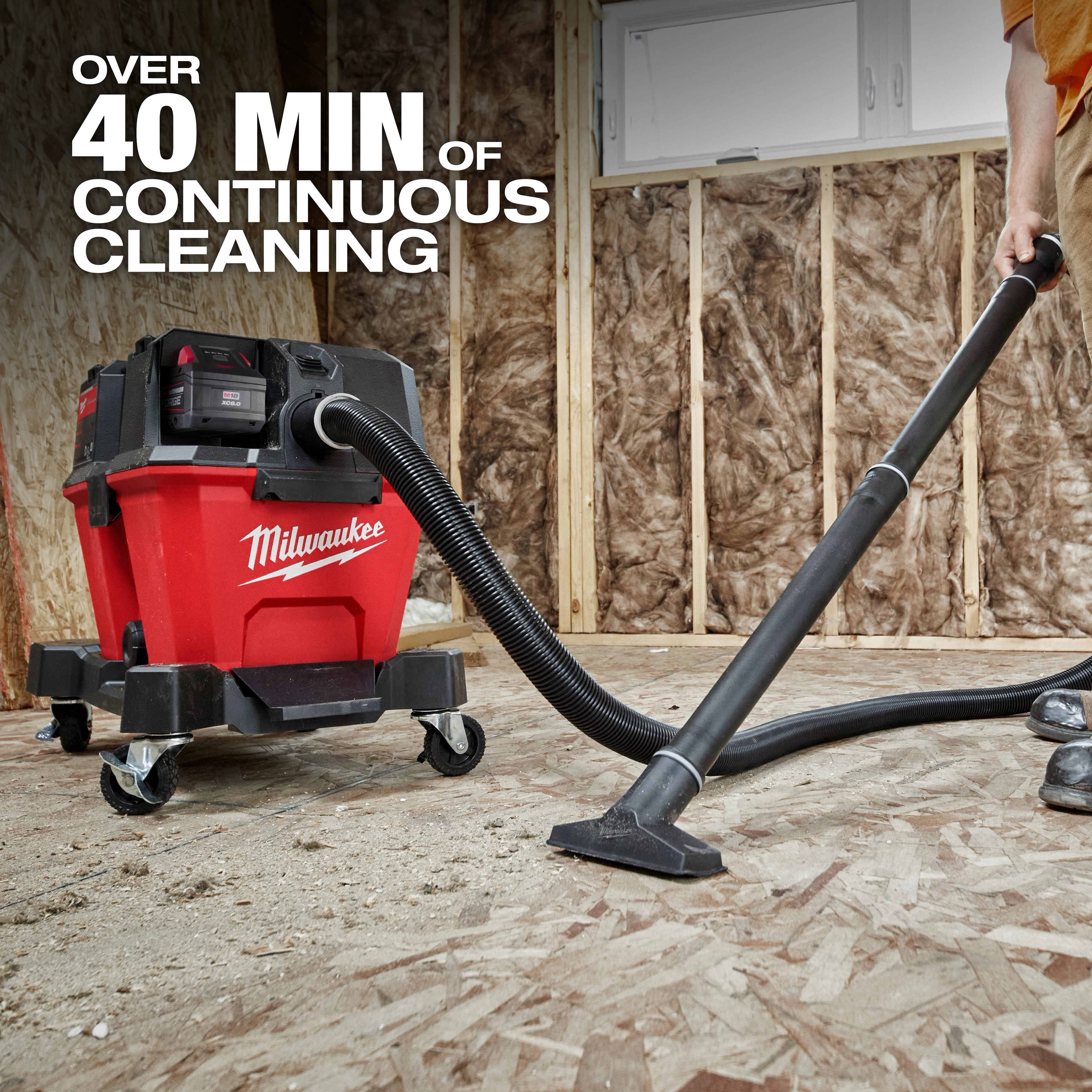 The image features the M18 FUEL™ NEXUS™ 6 Gallon Wet/Dry Vacuum, shown in a construction setting. A person operates the vacuum, demonstrating over 40 minutes of continuous cleaning. The vacuum is red with black attachments and wheels, branded with the Milwaukee logo.