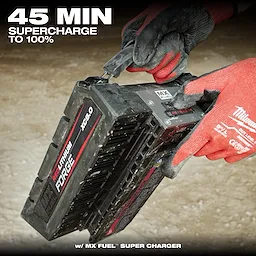 A person wearing red gloves inserts the MX FUEL™ REDLITHIUM™ FORGE™ XC8.0 BATTERY PACK into a charger. Text above reads "45 MIN SUPERCHARGE TO 100%." The battery pack is black with red and white labeling.