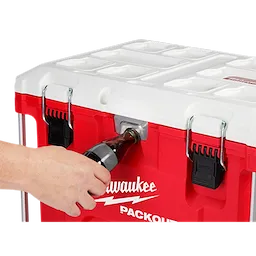 Worker using the integrated bottle opener attached to the PACKOUT Cooler