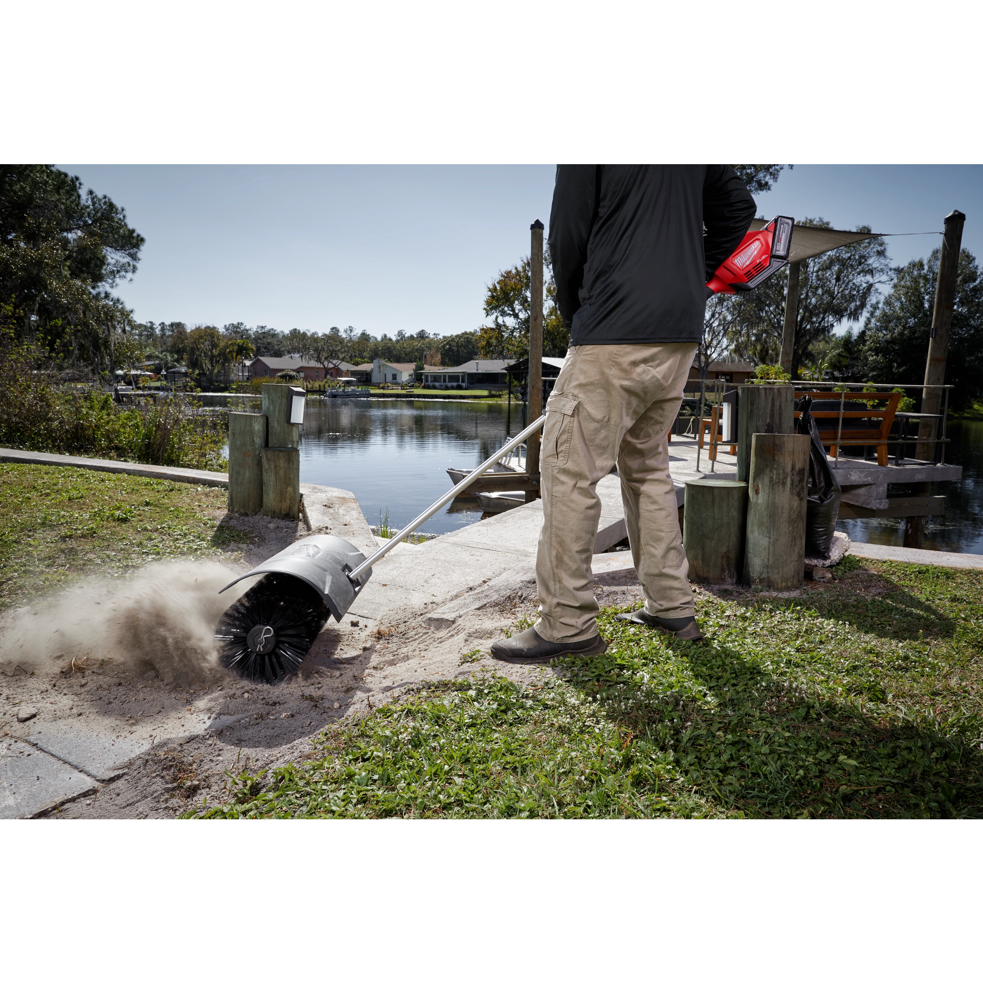 Worker using the M18 FUEL QUIK-LOK Bristle Brush Attachment