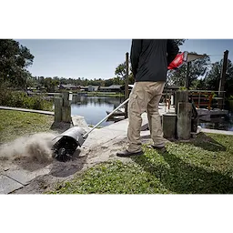 Worker using the M18 FUEL QUIK-LOK Bristle Brush Attachment